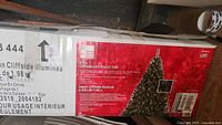 Box of the Home Accents LED pre-lit Christmas tree labeled 6.5 ft Cliffside model with LED lights included