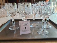 Set of six Marquis by Waterford crystal red wine glasses arranged on a tray showing their size and detailed cut pattern