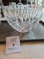 Crystal bowl shown from the front with intricate cut star and diamond shapes, placed on a tray with an auction tag number 5.