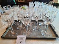 Set of 8 Waterford crystal water goblets arranged on a tray, showing the full set and the detailed cut crystal designs.
