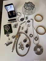 Full layout of all jewelry pieces and glass trinket dish