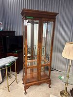Full front view of two-door wood and glass display cabinet