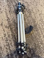 Collapsed Manfrotto tripod with strap visible