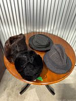 Four hats on round table
