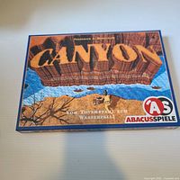 Front of Canyon board game box, Abacusspiele logo