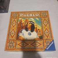 Front of Pueblo board game box showing title and artwork