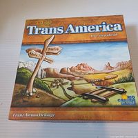 Front of TransAmerica box showing title, artwork, publisher logo