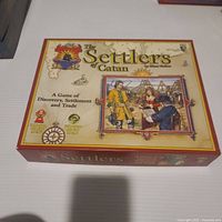 Closed box lid showing 2003 Settlers of Catan artwork
