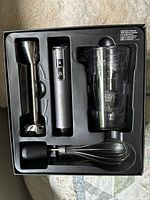 Full set in retail tray showing motor body, blending shaft, whisk adapter and beaker