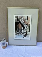 Full view of framed photo print beside soda can for scale