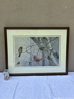 Framed print on table showing full artwork with soda can for scale