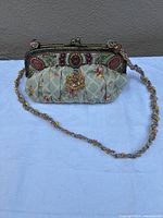 Front view of Mary Frances beaded floral purse with strap displayed