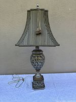 Full view of metal lamp with striped shade