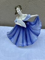 Front view of Royal Doulton Elaine figurine showing dress and fan