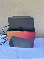 Front view of Sonos Play:3 on top of its box, power cord visible