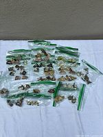 All zipper bags containing roughly 50 Wade figurines spread out