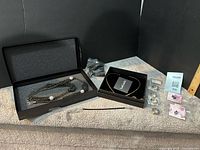 Group shot showing necklace in gift box, Loverocks choker box, bracelet, rings, charms, keychain