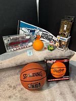Group shot of all nine items including basketballs, figures, license frame, pennant, dispenser, eraser