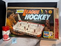 Boxed Munro Junior League Hockey game with Aladdin thermos beside it
