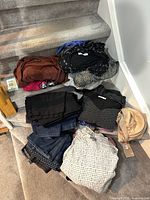 Pile of assorted clothing on stairs showing variety of garments