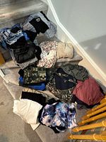 Overall lot of mixed ladies clothing piled on stairs