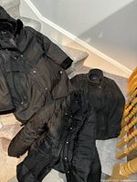 Three coats laid out on stairs