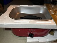 Roaster oven with lid inside shipping foam