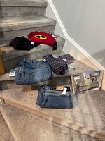 All five new clothing items laid out on stairs