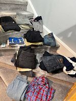 Overview of assorted jeans, pants, T-shirts on stair steps
