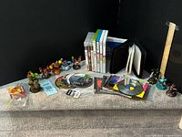 Entire lot overview showing games, CDs, Skylanders figures, CD wallet and picture