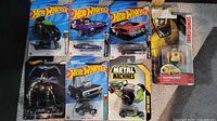 Group shot of all seven sealed vehicle toys