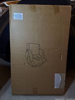 Front of sealed box showing line drawing of stadium seat