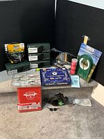 Overview of all items on steps: sunglasses boxes, bike lock, advent calendar, lures, golf accessories, reading glasses