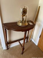 Side table with clock displayed on top