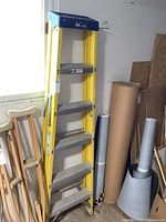 Full front view of yellow 6 ft fiberglass step ladder