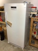 Full view of white Frigidaire upright freezer