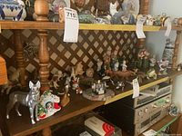 Shelf with numerous animal figurines and beer stein