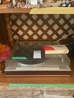 Luxman turntable with dust cover and Ortofon box on platter