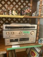 Three Luxman components stacked on shelf: tuner T-240, amplifier L-240, cassette deck K-240