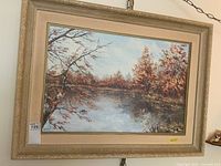 Full view of framed oil painting, showing landscape scene and frame