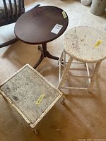 Three items: oval wood side table, white wooden stool, metal step stool