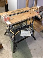 Overall view of Black & Decker Workmate 400 folding workbench showing wood top, metal frame and accessories bag