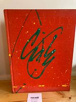 Front cover showing painted signature and splatter design