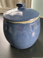 front view of blue pottery canister with lid