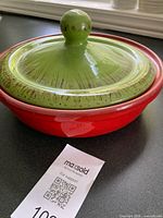 Casserole assembled showing red bowl and green lid with knob
