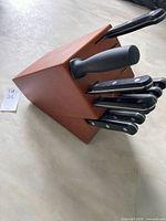 Side view of wood block with knives inserted