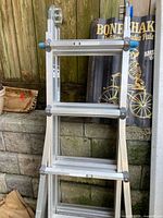 Full view of folded ladder against wall