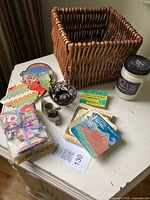 Group shot showing all items: wicker basket, candle, coasters, invitations, metal candle holders, incense paper booklet