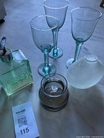 Group view: three wine glasses, soap dispenser, Dansk glass piece, frosted vase