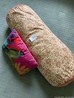 Both pillows on carpet showing sizes and patterns